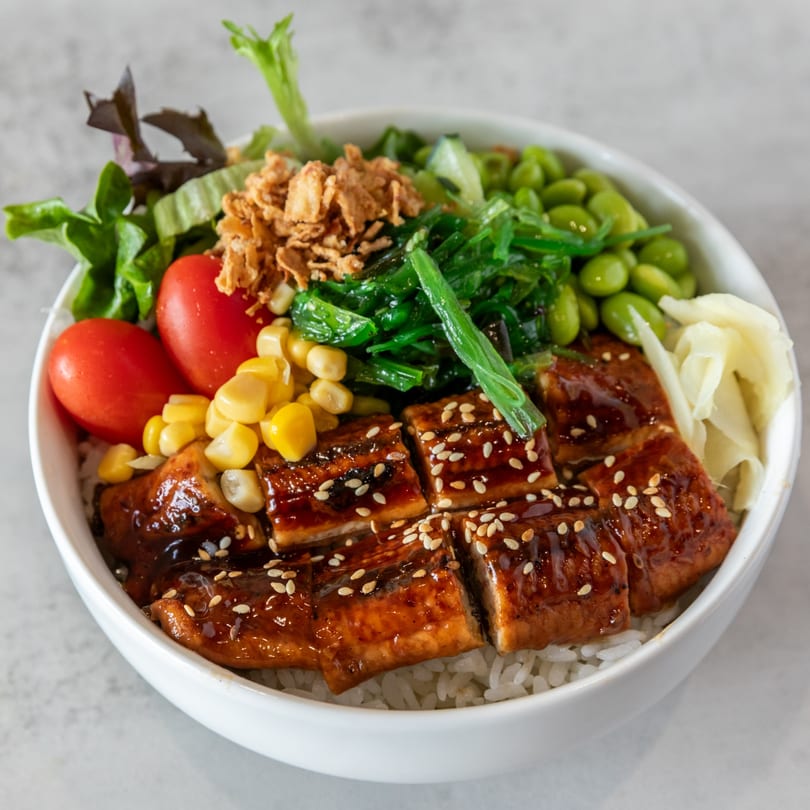 Poke Bowl's unagi bowl with eel, rice, corn, tomatoes, seaweed, edamame, and pickled ginger.